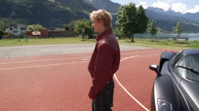 Orbit: the camera travels round him and the car while he talks, the court and the lake turning behind them